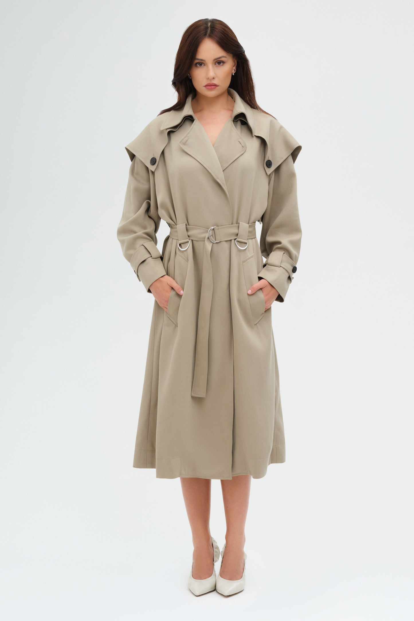 Woman wearing a beige trench coat on a white background