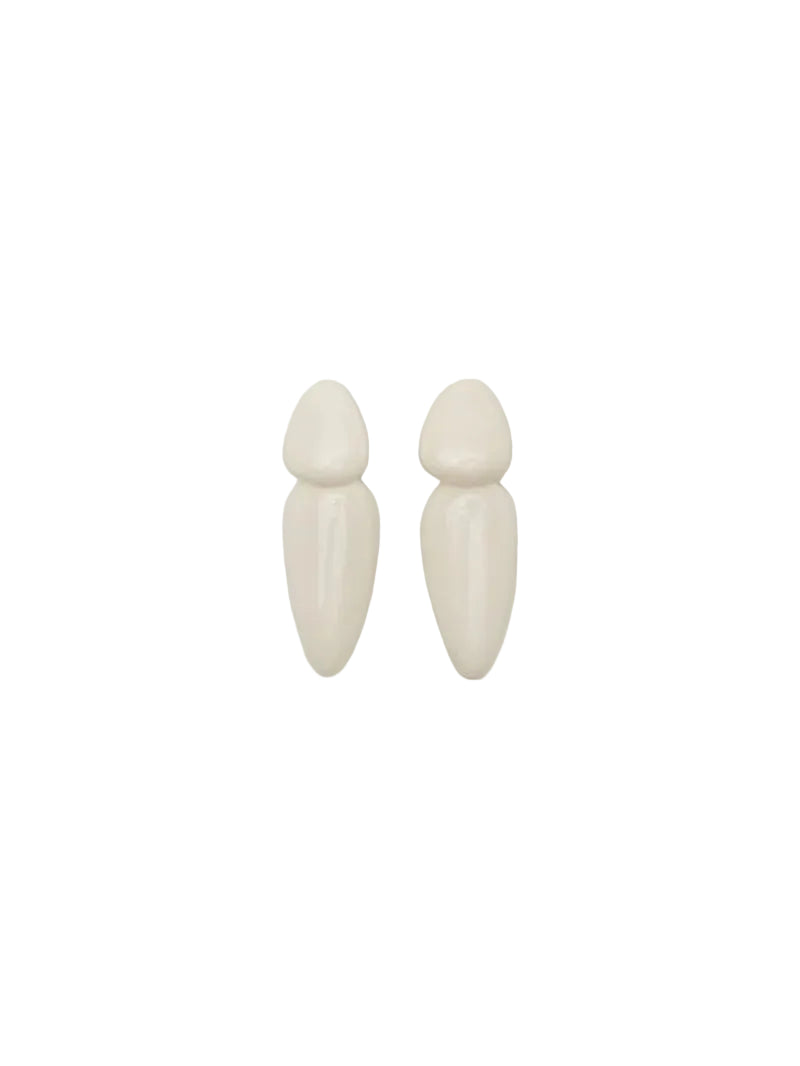 Pair of white earrings on a light beige background