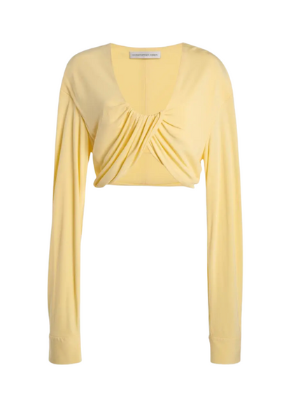 Yellow long-sleeve top with a draped design on a white background