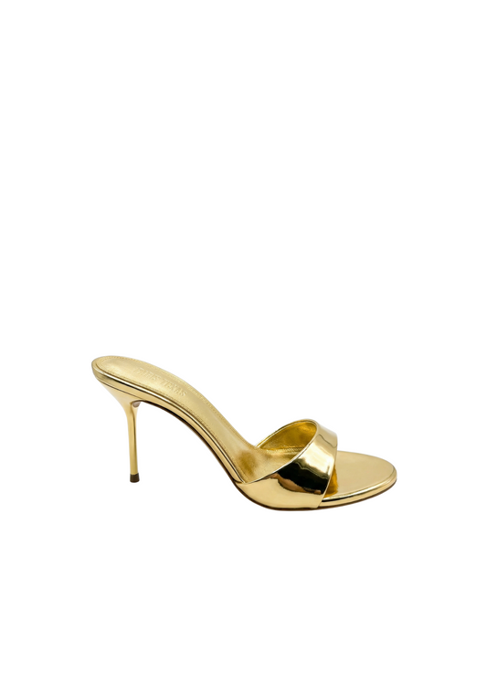 Gold high-heeled sandal on a white background