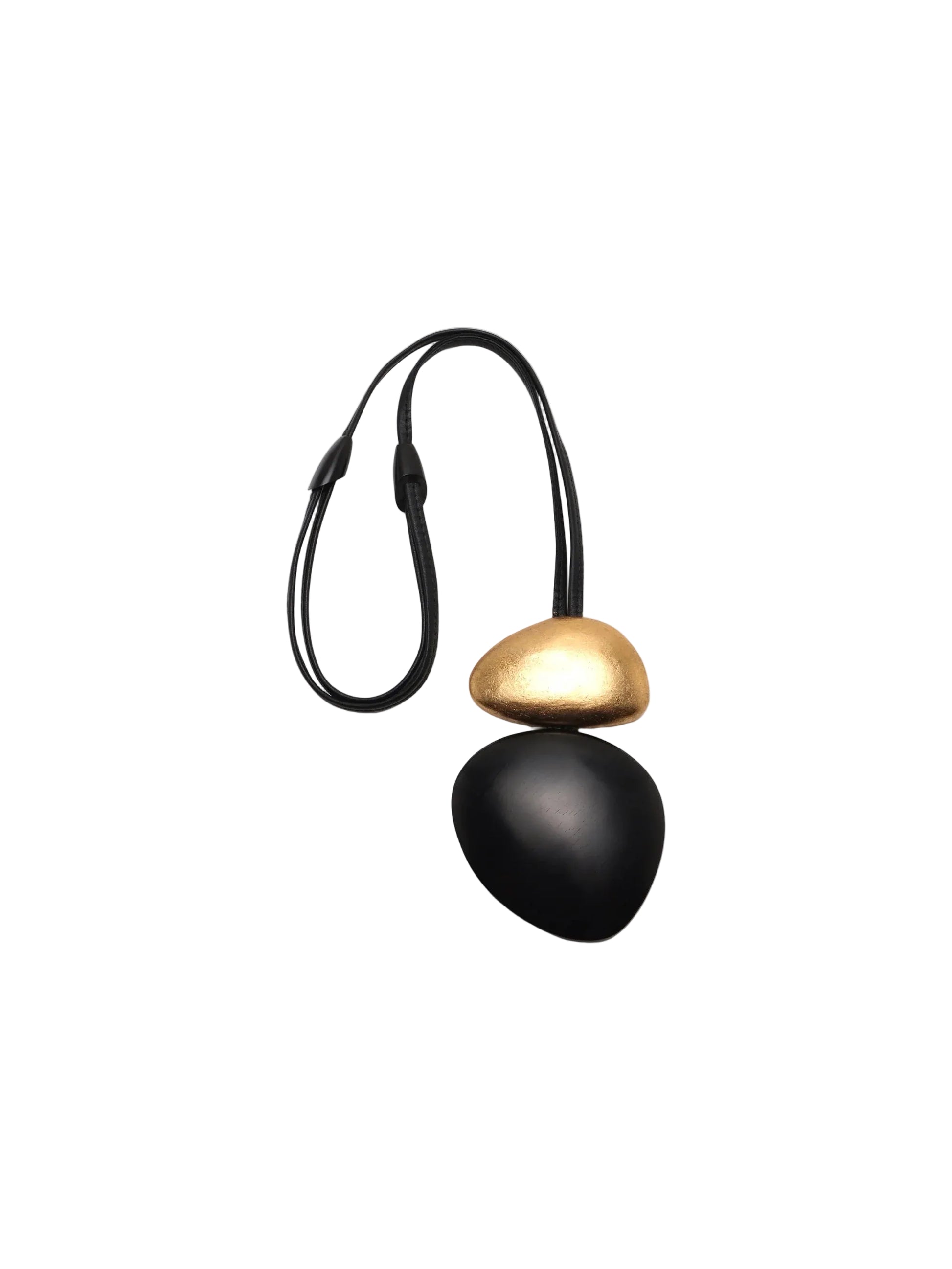 Black and gold pendant on a white background