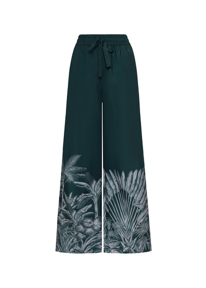 Dark green wide-leg pants with tropical leaf pattern on a white background