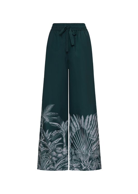 Dark green wide-leg pants with tropical leaf pattern on a white background