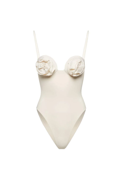 White swimsuit with floral details on a white background