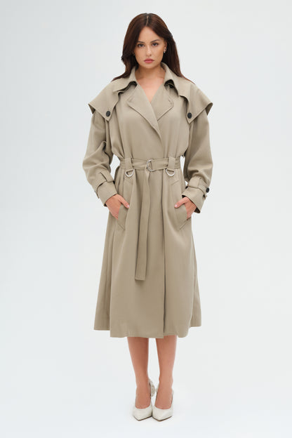 Woman wearing a beige trench coat on a white background