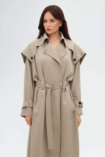 Woman wearing a beige trench coat on a white background