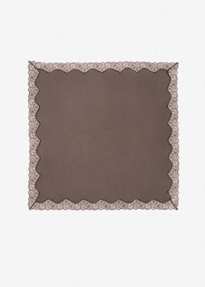 Brown square fabric with decorative lace trim on a white background