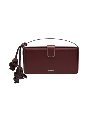 Brown leather handbag with a strap on a white background