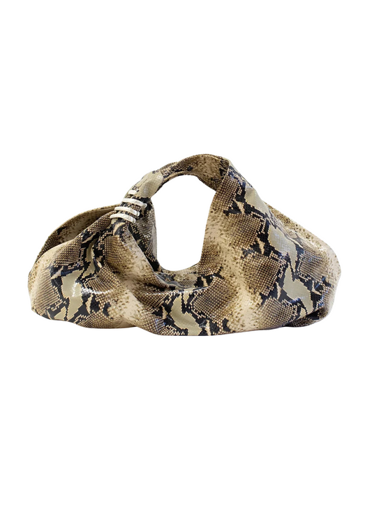 Snakeskin-patterned dog muzzle on a white background