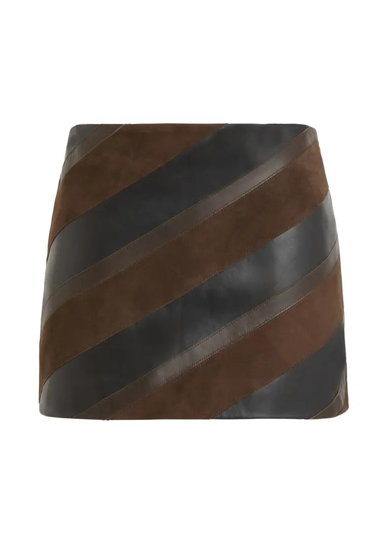 A mini skirt featuring diagonal striped panels of dark brown suede and black faux leather, shown against a plain white background.
