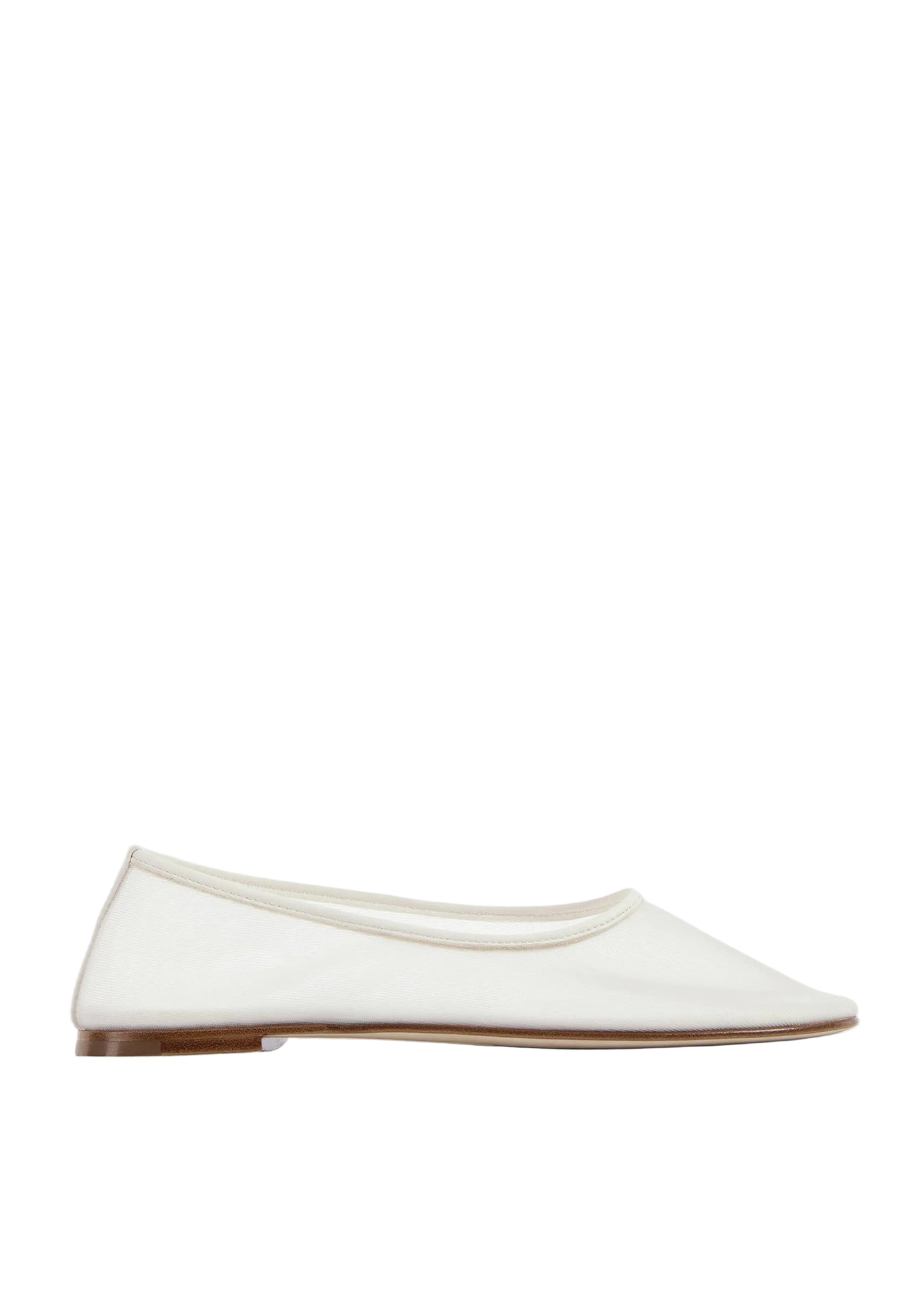 White flat shoe on a light beige background