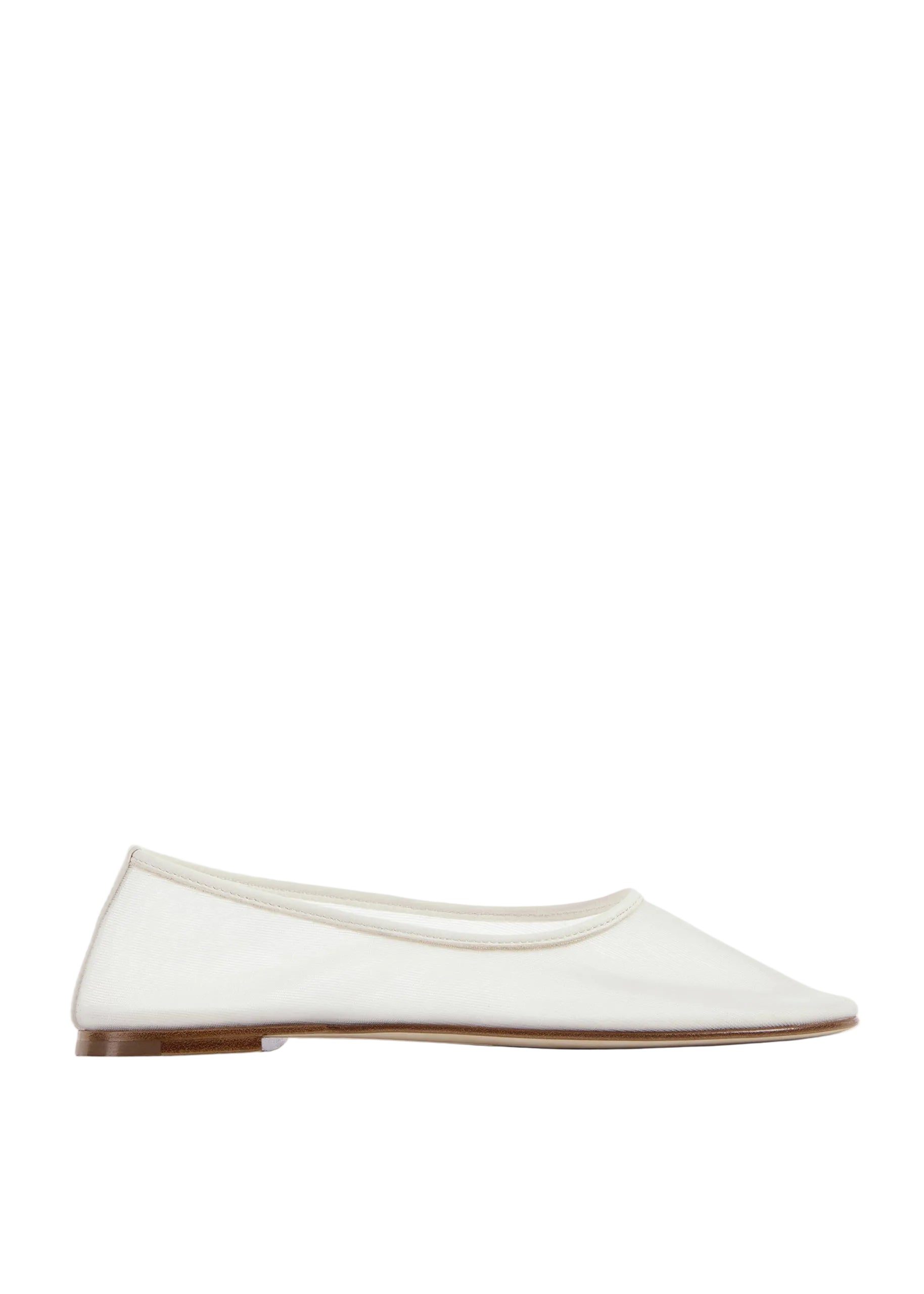 White flat shoe on a light beige background