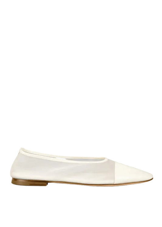 White flat shoe with a brown sole on a white background