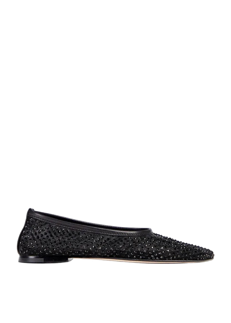 Black studded flat shoe on a light gray background
