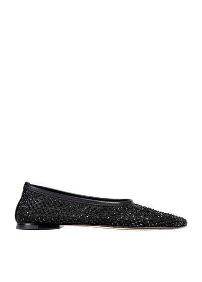 Black studded flat shoe on a light gray background